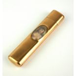 AN EDWARDIAN YELLOW METAL EROTIC RECTANGULAR NEEDLE CASE Set with a glazed oval nude portrait. (