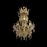 A 19TH CENTURY FRENCH GILT EIGHT BRANCH CHANDELIER The scrollwork frame festooned with crystal prism