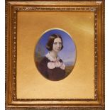 A LATE 19TH/EARLY 20TH CENTURY OIL ON CARD Portrait of a young lady with pink bow in oval gilt