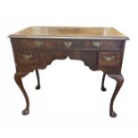AN 18TH CENTURY DESIGN FIGURED WALNUT WRITING/DRESSING TABLE With one long above two short drawers