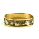 A VINTAGE 9CT GOLD EQUESTRIAN BANGLE Set with eight horse head motifs. (approx diameter 6.5cm)