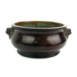 A CHINESE BRONZE CIRCULAR CENSER Having twin mask handles and cast with a six character 'Xuande'