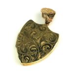 A VICTORIAN DESIGN 9CT GOLD HEART FORM LOCKET Having engraved scrolled decoration and two interior