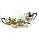 AN EARLY 20TH SILVER PLATED FOUR PIECE TEA SERVICE Comprising a teapot, hot water jug, sugar and