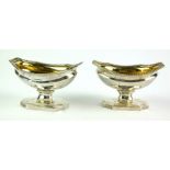 A PAIR OF GEORGIAN SILVER SALTS Classical form with gadrooned border and gilt interior on stepped