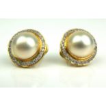 A PAIR OF 18CT GOLD, PEARL AND DIAMOND EARRINGS Having a single pearl edged with diamonds. (pearl