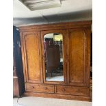 A VICTORIAN SATIN WALNUT TRIPLE WARDROBE The central mirrored door enclosing linen slides and