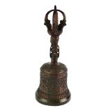 A LARGE TIBETAN BRONZE BELL Having a Dorji form handle and raised decoration of mythical beasts