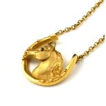 A VINTAGE 9CT GOLD EQUESTRIAN PENDANT NECKLACE A horse head within a horseshoe on a fine link 9ct