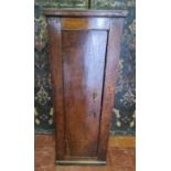 A 19TH CENTURY OAK PEDESTAL CUPBOARD The single door opening to reveal enclosed shelves. (39cm x