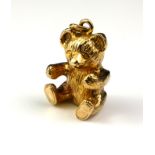 A VINTAGE 9CT GOLD 'TEDDY BEAR' PENDANT Seated pose with circular bale. (approx 3cm)
