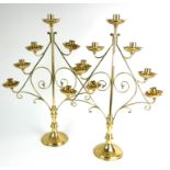 A PAIR OF EARLY 20TH CENTURY ECCLESIASTICAL BRASS CANDELABRA Each having seven sconces, scroll