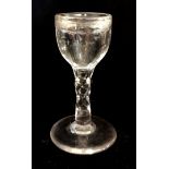 A VICTORIAN PENNY LICK ILLUSION GLASS Engraved decoration of stars and swags, on a faceted stem with