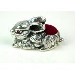 A STERLING SILVER NOVELTY RED VELVET RABBIT PIN CUSHION Having cabochon cut stones to eyes. (