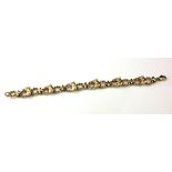 A 9CT GOLD EQUESTRIAN BRACELET The row of six horse head motifs on rope twist form links. (approx