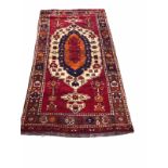 A MIDDLE EASTERN RUG OF TRADITIONAL STYLE With central lozenge contained within running borders. (