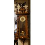 A 19TH CENTURY WALNUT VIENNA REGULATOR WALL CLOCK Having a carved eagle finial, column supports,