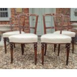 A SET OF FOUR VICTORIAN MAHOGANY DINING CHAIRS With beige fabric upholstered overstuffed seats. (