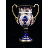 ROYAL CROWN DERBY, AN EARLY 20TH CENTURY PORCELAIN TWIN HANDLED CUP Hand painted in the Imari