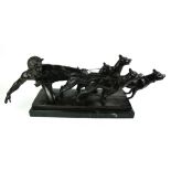 A PATINATED BRONZE GROUP, SEMICLAD MALE RESTRAINING FOUR HOUNDS On black marble base, signed '