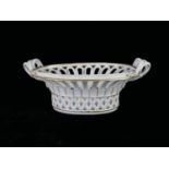 AN 18TH CENTURY CONTINENTAL HARD PASTE PORCELAIN SNAKE FORM TWIN HANDLED OVAL BASKET With openwork