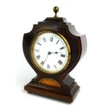 AN EDWARDIAN MAHOGANY BOUDOIR CLOCK Art Nouveau curved form case with inlaid shell decoration and