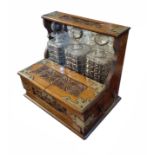 A VICTORIAN OAK AND BRASS MOUNTED THREE BOTTLE TANTALUS With a fitted compartment. (36cm x 26cm x
