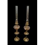 A PAIR OF 19TH CENTURY FRENCH BRASS AND GLASS OIL LAMPS Having elongated glass flues, hand painted