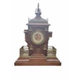 A LATE 19TH/EARLY 20TH CENTURY CONTINENTAL OAK AND BRASS ARCHITECTURAL CLOCK CARVED AS A GOTHIC