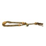 A VICTORIAN 9CT GOLD ALBERTINA WATCH CHAIN Having an oval form slider, tassel and intaglio carved