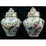 A PAIR OF LATE 19TH/EARLY 20TH CENTURY CONTINENTAL PORCELAIN VASE AND COVERS Having applied floral