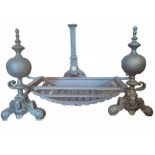 A PAIR OF CAST IRON BAROQUE FORM FIRE DOGS/ANDIRONS Having spherical finials with classical masks to