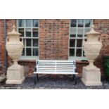 A LARGE AND IMPRESSIVE PAIR OF GRECIAN DESIGN FAUX TERRACOTTA URNS AND COVERS ON STANDS With