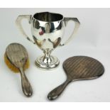 AN ART DECO SILVER TWIN HANDLED TROPHY CUP Hallmarked London, 1933, together with a vanity mirror