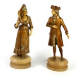 A PAIR OF EARLY 20TH CENTURY GILT BRONZE, SILVERED AND IVORY STATUES, COURTING COUPLE On circular