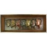 AN EARLY 20TH CENTURY CONTINENTAL BRONZE GROUP RECTANGULAR PORTRAIT PLAQUE With seven embossed heads