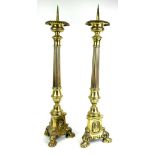 A PAIR OF 19TH CENTURY BRASS GOTHIC PRICKET CANDLESTICKS The turned reeded columns above portrait