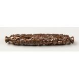 AN EARLY 19TH CENTURY FRENCH CARVED COQUILLA NUT TWO PART NEEDLE CASE