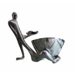 CARROL BOYES, ALUMINIUM TABLE CENTERPIECE Male figure with freestanding bowl resting between legs,