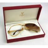 MUST DE CARTIER, A PAIR OF VINTAGE GOLD PLATED SUNGLASSES Having burgundy finials, marked '62 14' to