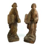 A PAIR OF EARLY 20TH CENTURY CONTINENTAL HARDWOOD STATUES OF MOSES Holding commandment tablets. (