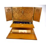 AN EDWARDIAN OAK AND SILVER TRAVELLING ALTAR/HOLY COMMUNION SET The folding case set with a white