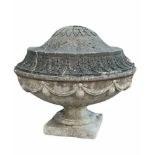 A REGENCY DESIGN COVERED URN Reconstituted stone relief decoration urns and swags. (diameter 60cm