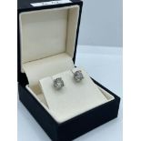 A PAIR OF 18CT WHITE GOLD AND FOUR CLAW SET 2.02CT BRILLIANT CUT CHAMPAGNE DIAMOND STUDS. (colour