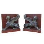 A PAIR OF BRONZE WINGED SPHINXES (NOW CONVERTED TO BOOKENDS). (h 18cm x d 10cm x w 18cm)