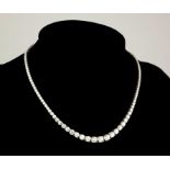 AN 18CT WHITE GOLD AND GRADUATED ROUND BRILLIANT CUT DIAMOND ETERNITY NECKLACE. (approx diamond