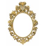 A LARGE 19TH CENTURY ITALIAN CARVED GILTWOOD FLORENTINE OVAL MIRROR With scrolling foliage leaf