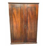 AN EARLY 19TH CENTURY MAHOGANY TABLE TOP COLLECTORS CABINET The panel doors opening to reveal fitted