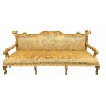 MANNER OF WILLIAM KENT, A LARGE DECORATIVE CARVED GILTWOOD UPHOLSTERED SETTEE With scrolling foliage