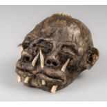 A 20TH CENTURY IMITATION LEATHER DIPROSOPUS (TWO-FACED) SHRUNKEN HEAD. (h 9.5cm x w 14cm x d 11.5cm)